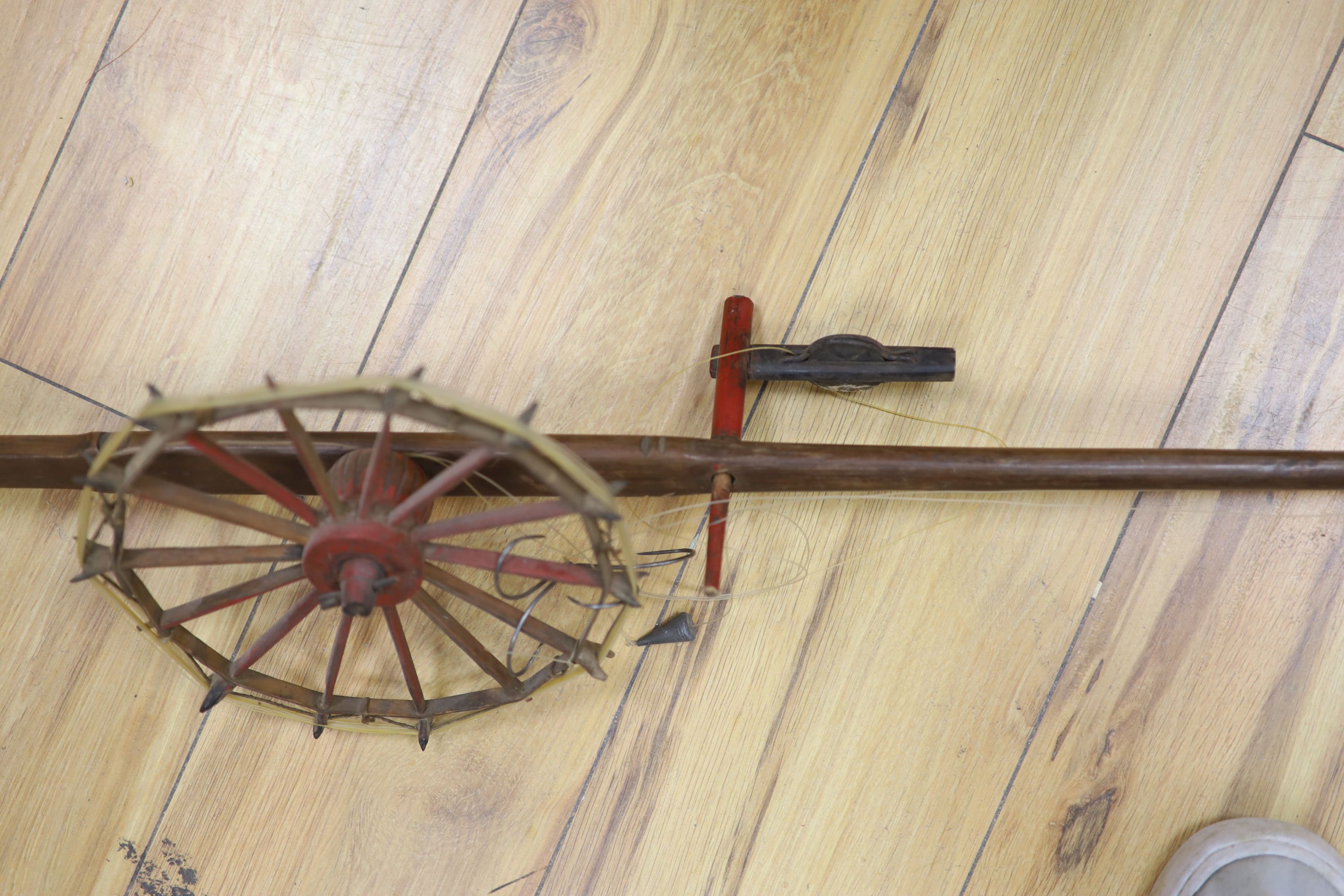 A Chinese wood and bamboo fishing rod with reel, Qing Dynasty, approx. length 142cm